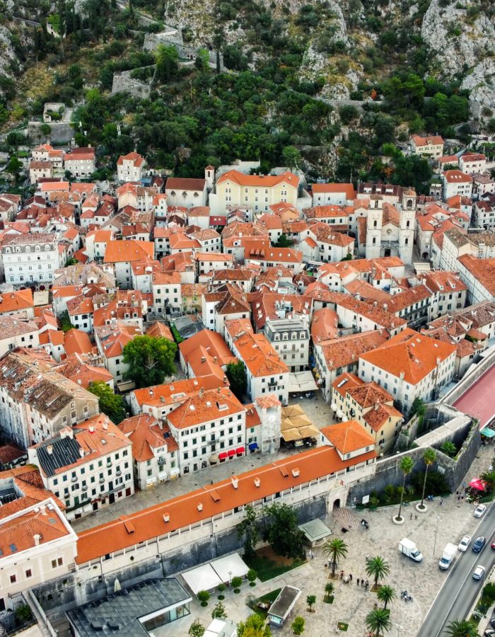Aerial drone view of a small town in Montenegro. Town with residential buildings located on the Adriatic coast, greenery